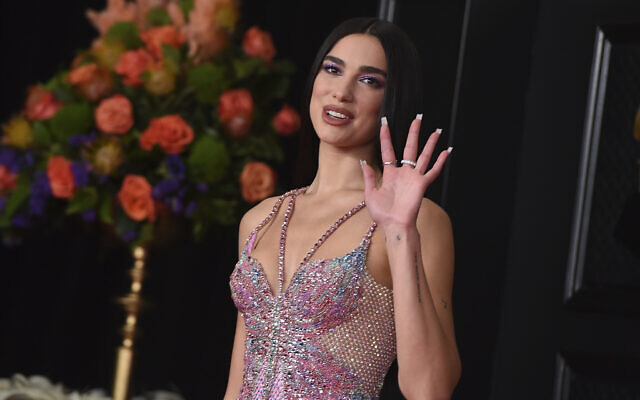 FILE - In this Sunday, March 14, 2021 file photo, Dua Lipa arrives at the 63rd annual Grammy Awards at the Los Angeles Convention Center. British music's leading prize night next month will feature an audience of 4,000 people, in what will be the first major indoor music event in the country to welcome back a live audience since the coronavirus pandemic erupted more than a year ago. “This has been a long tough year for everyone and I’m delighted the night will honor the key worker heroes who have cared for us so well during that time and continue to do so,” said singer/songwriter Dua Lipa, who is set to perform at the event. (Photo by Jordan Strauss/Invision/AP, File)