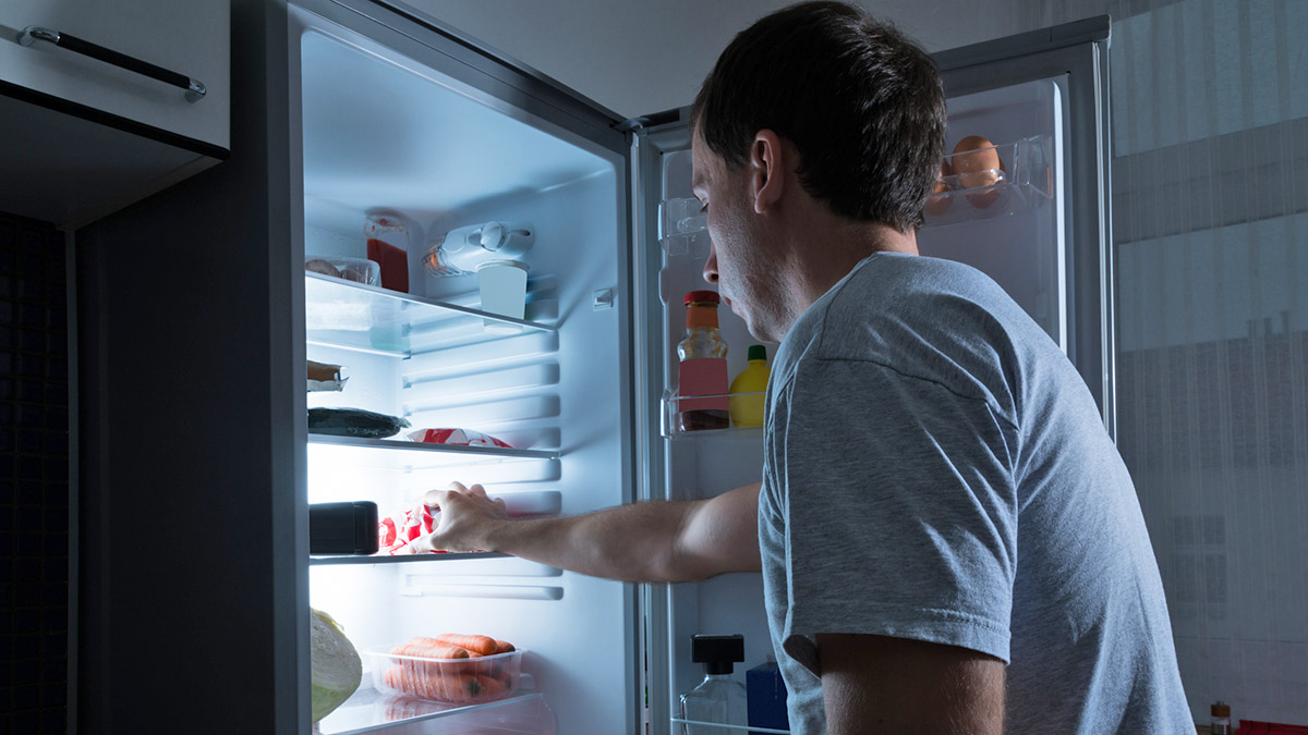 Portrait Of A Man Taking Food From Refrigerator