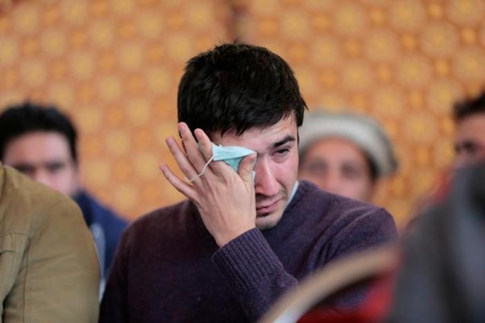 Relatives grieve as they wait for word on the collection of the remains of victims of the Pakistan International Airlines (PIA) plane crash at PIMS hospital in Islamabad