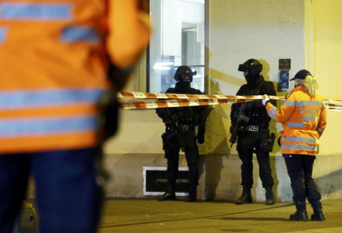 Police stand outside an Islamic center in central Zurich