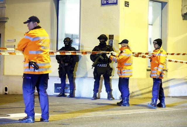 Police stand outside an Islamic center in central Zurich