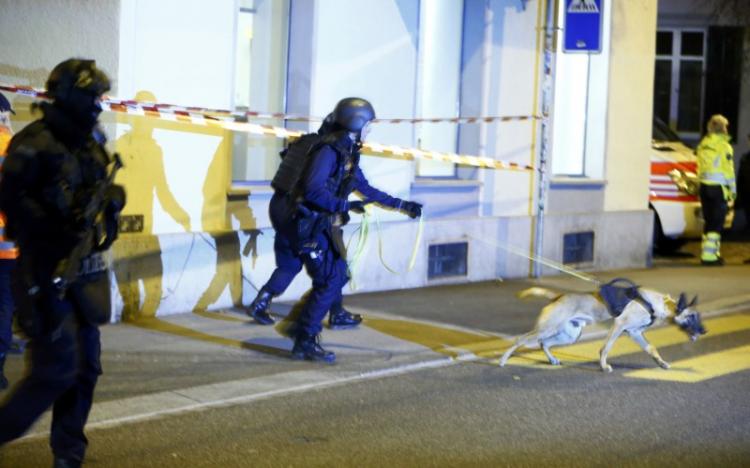 Police stand outside an Islamic center in central Zurich