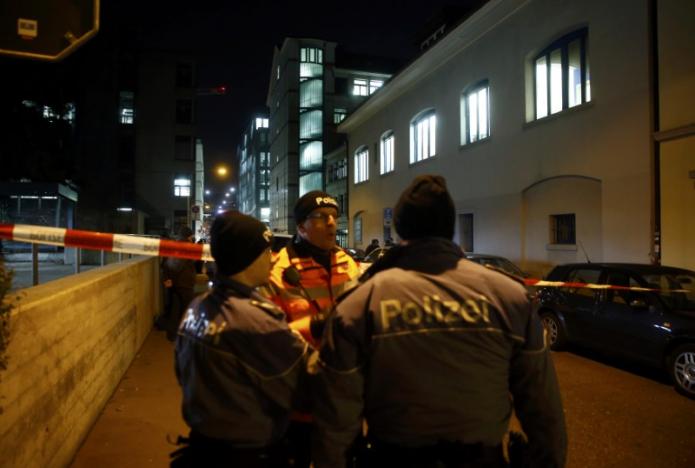 Police stand outside an Islamic center in central Zurich