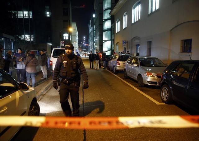 Police stand outside an Islamic center in central Zurich